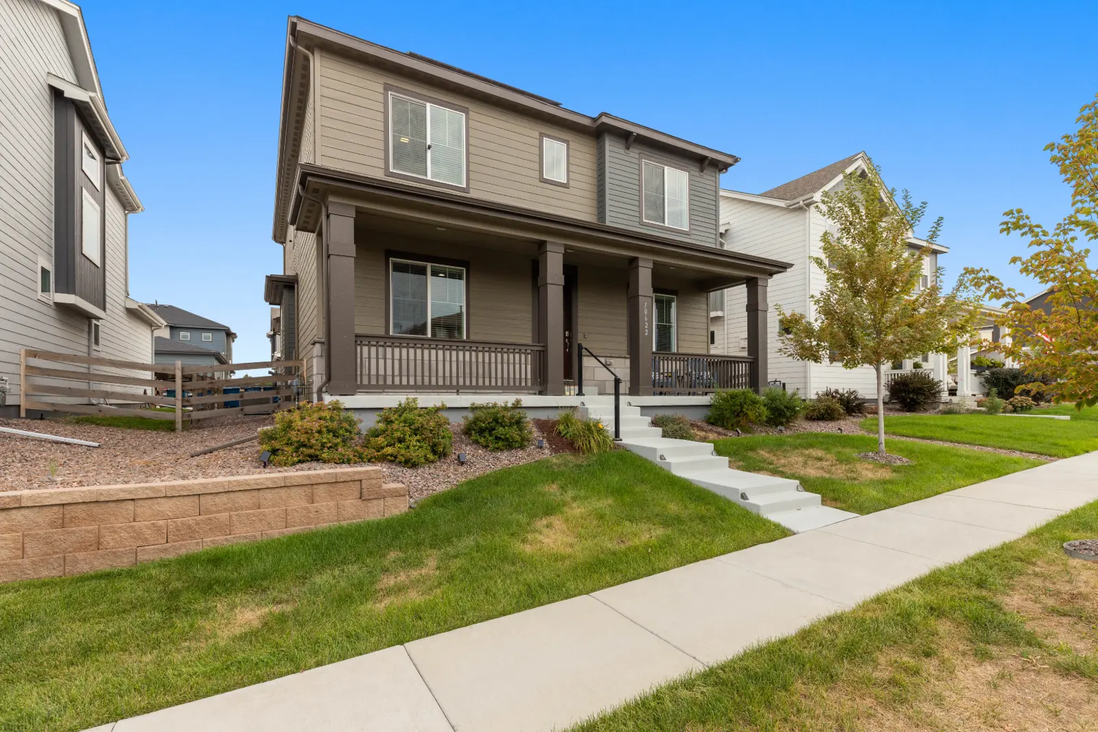 Front exterior of 10622 Truckee Street, Commerce City with covered porch and landscaped entry