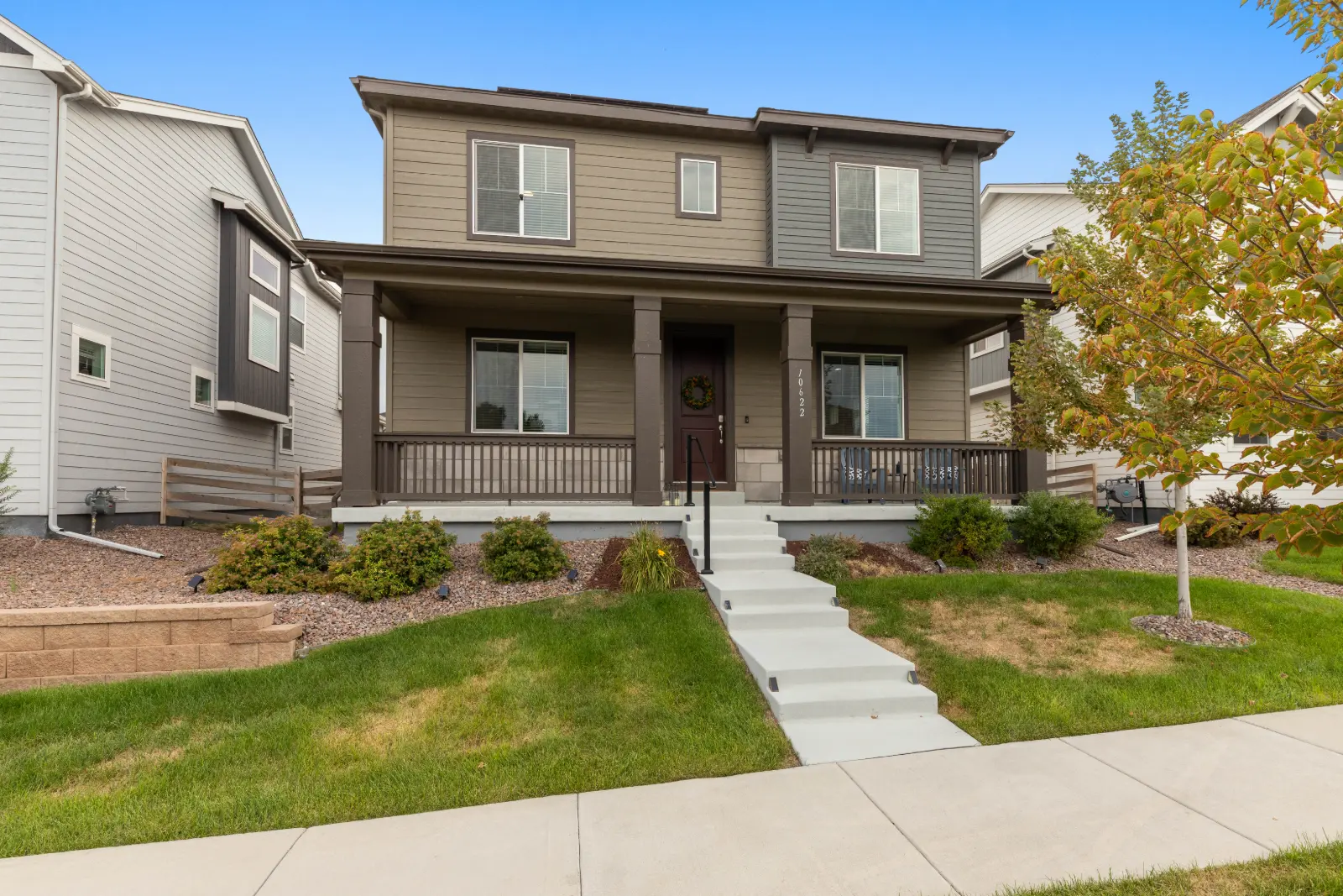 Front of 10622 Truckee Street, Commerce City from the walkway, two-story home with covered porch