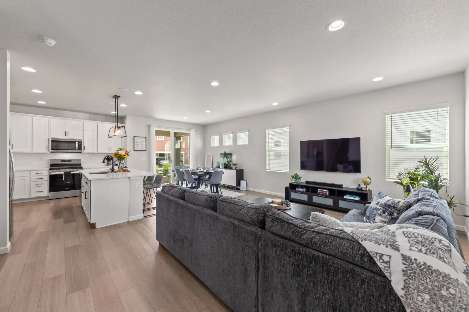 Open living room and kitchen at 10622 Truckee Street, Commerce City with wide-plank floors